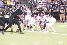 Atlanta’s big offensive line prepares to run another play with quarterback Chase Musgrove in the shotgun