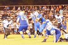 Linden-Kildare running back Micah Harrison fights for extra yardage with a Redwater defender on his waist. Harrison racked up 84 rushing yards, one of them a 35-yard outburst, on 13 carries with two touchdowns for the Tigers.