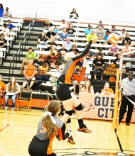 Queen City’s Brianna “Hot-shot” Watkins blazes a ball over the net for a point.