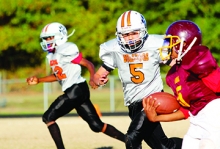 Queen City’s Noah Perkins “brings the thunder” as he puts a Lions’ ball carrier in his crosshairs.