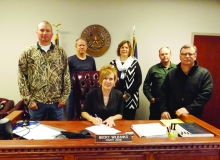 County Judge Becky Wilbanks signs the World Austism Awarness Day proclamation for Cass County.